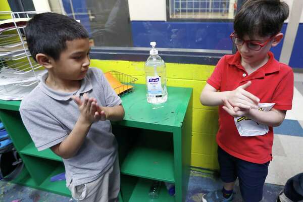 Victor Parache, 6, left, and Emiliano Arango, 7, use the hand sanitizer at the Heights Boys and Girls Club, in Houston,Thursday, March 12, 2020. While local health officials are still recommending that schools remain open amid coronavirus fears, the looming threat of canceling K-12 classes means parents are making child care plans and local organizations are making preliminary plans to accommodate kids. Experts said the region’s experience with recent natural disasters and the gradual ramp-up of the coronavirus gives time for agencies to make preparations. Still, parents are concerned about student health and school cancellations could be difficult for working parents without easy access to child care.