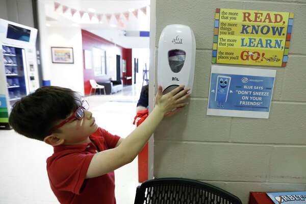 Emiliano Arango, 7, uses the hand sanitizer at the Heights Boys and Girls Club, in Houston,Thursday, March 12, 2020. While local health officials are still recommending that schools remain open amid coronavirus fears, the looming threat of canceling K-12 classes means parents are making child care plans and local organizations are making preliminary plans to accommodate kids. Experts said the region’s experience with recent natural disasters and the gradual ramp-up of the coronavirus gives time for agencies to make preparations. Still, parents are concerned about student health and school cancellations could be difficult for working parents without easy access to child care.