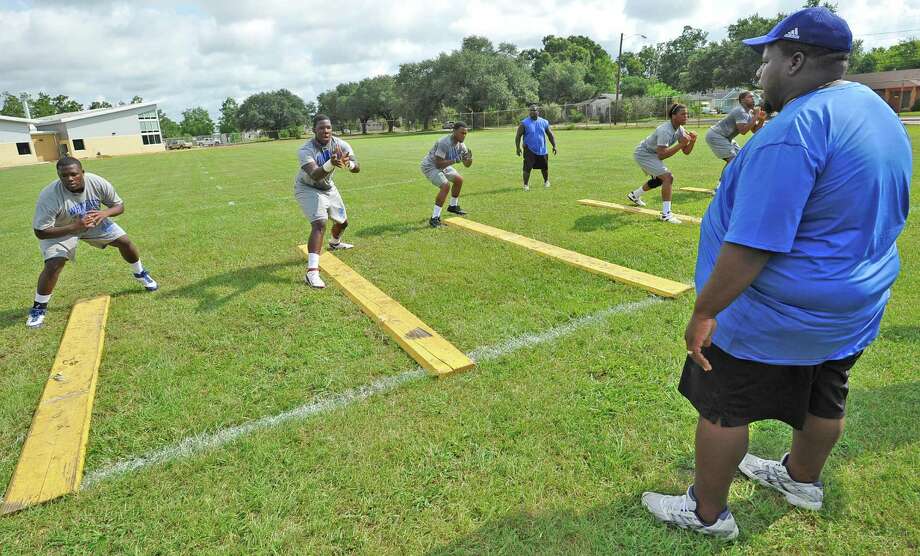 offensive line coach ed taylor yells instructions to his players