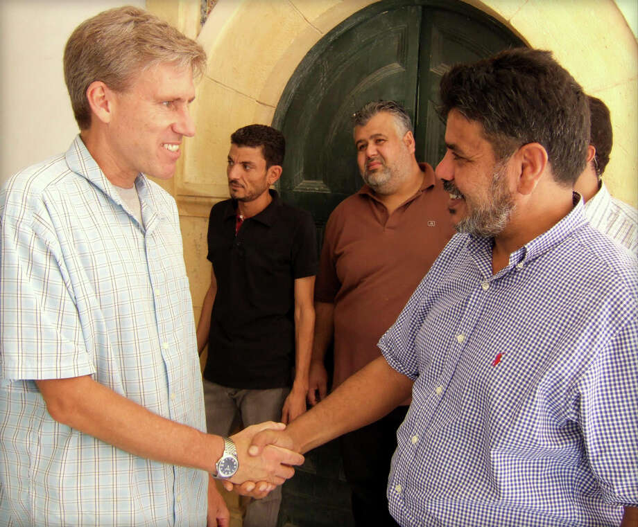 libya christopher stevens, left, shakes hands with a libyan man