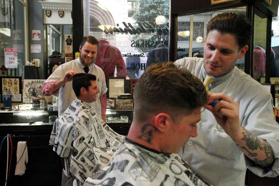 the barber\\'s,lancebarber on the hair of brandon brown, 29, right, in nicky the barber"s