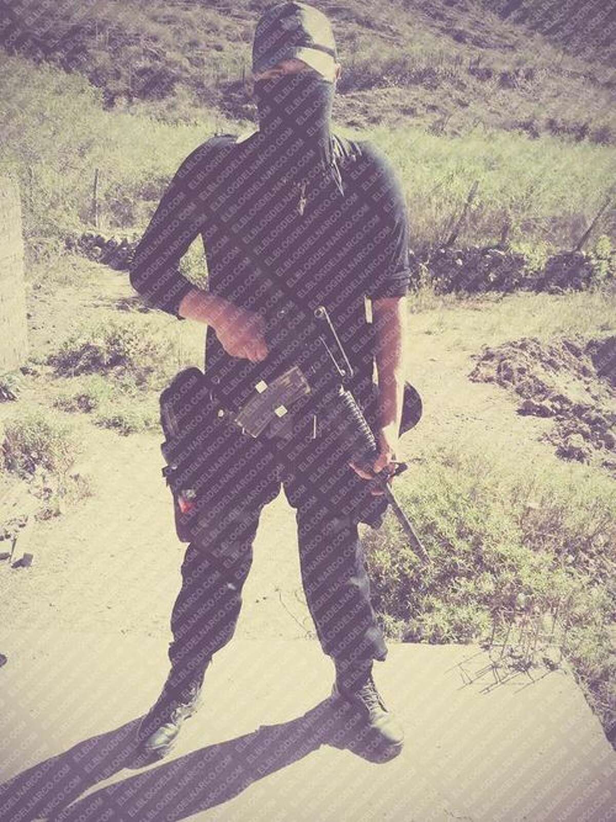 Masked assassins for the Juárez Cartel in Mexico shown holding guns in