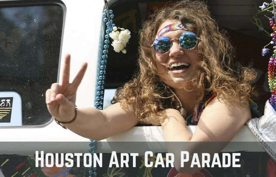 art car parade participant waves at the paradegoers from the 