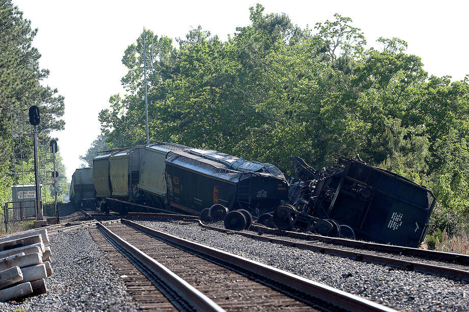 and transportation crews survey the damage of a train derailment