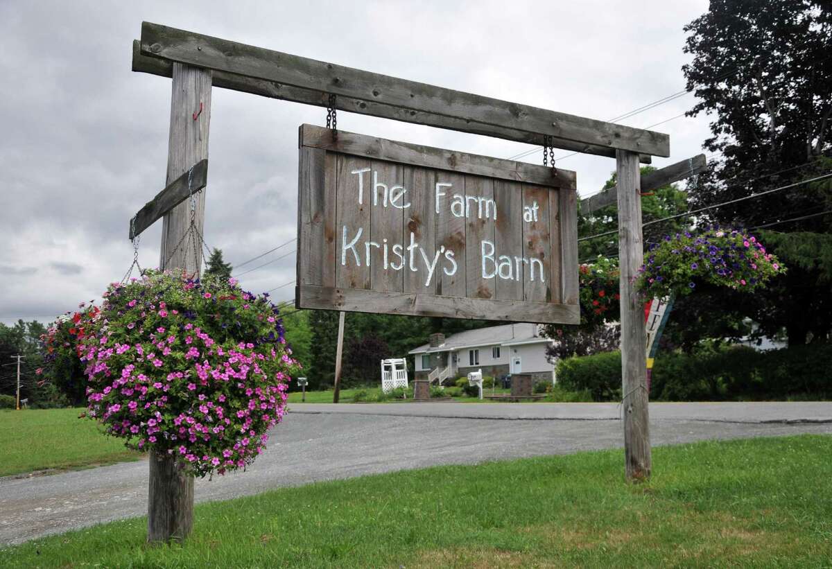 A rustic sign reads The Farm at Kristy's Barn