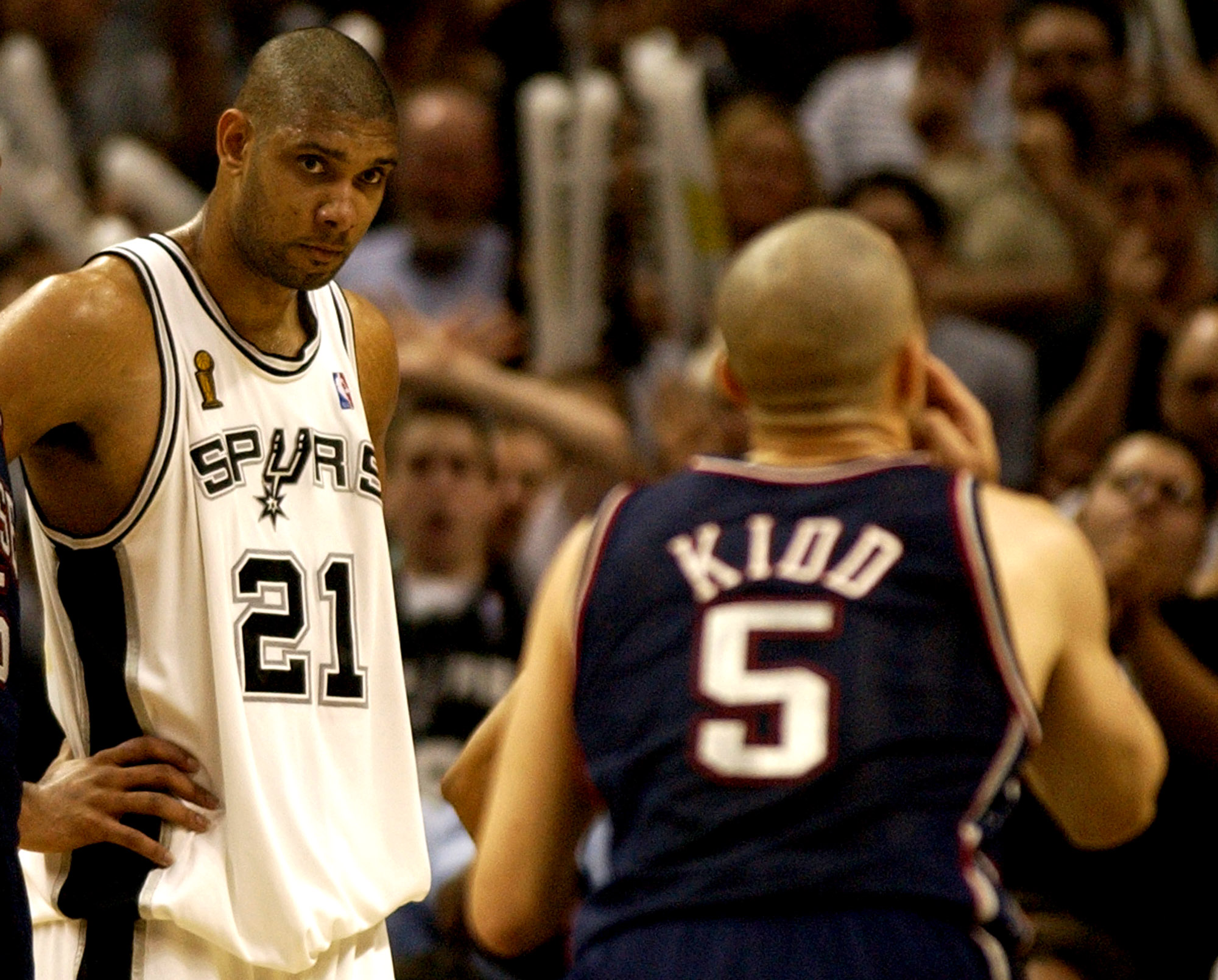 Tim Duncan staring at Jason Kidd while he is shooting a free throw.