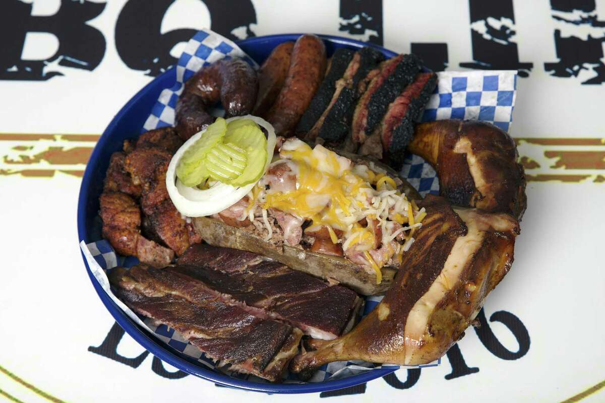 A tray of brisket, ribs, pulled pork, sausage and loaded baked potato at BBQ Life.