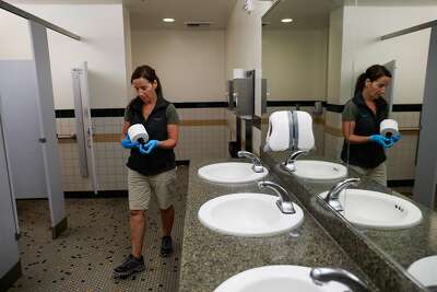 Grazia cleaning a bathroom at California State University Chico