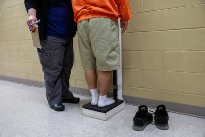 An incarcerated youth is weighed at the Fresno County juvenile hall in Fresno.