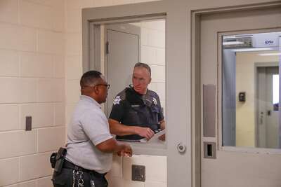 Fresno County probation Officer Kevin Lee (left) speaks with a police officer at the county’s juvenile hall in Fresno.