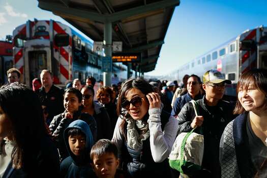 A crowd of people walk through the Fourth and King Street Caltrain station in San Francisco, California, on Monday, Jan. 21, 2019.