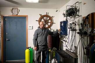 Keith Cormican fills air tanks in his scuba dive shop, Wazee Sports Center, in Black River Falls, Wisconsin.