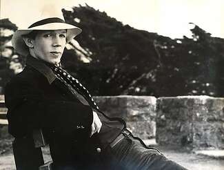 Jae Stevens poses in a white hat with a wide brim.