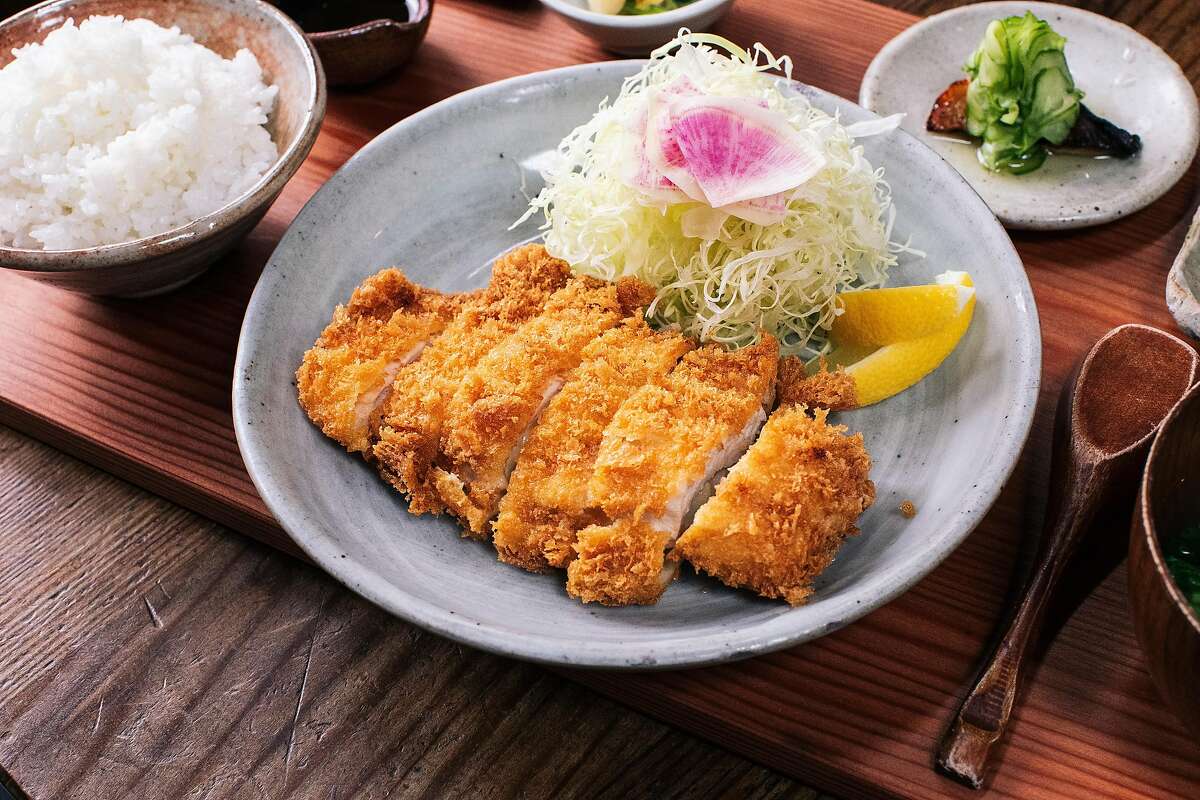 Crispy chicken katsu and shaved cabbage on a blue plate.
