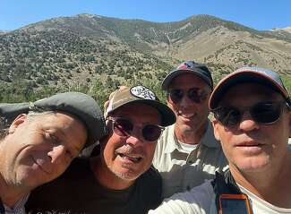 A photo of Jim Webb, Ron Bolen, Mark McConnell and Brad Schick after they rescued Bolen.