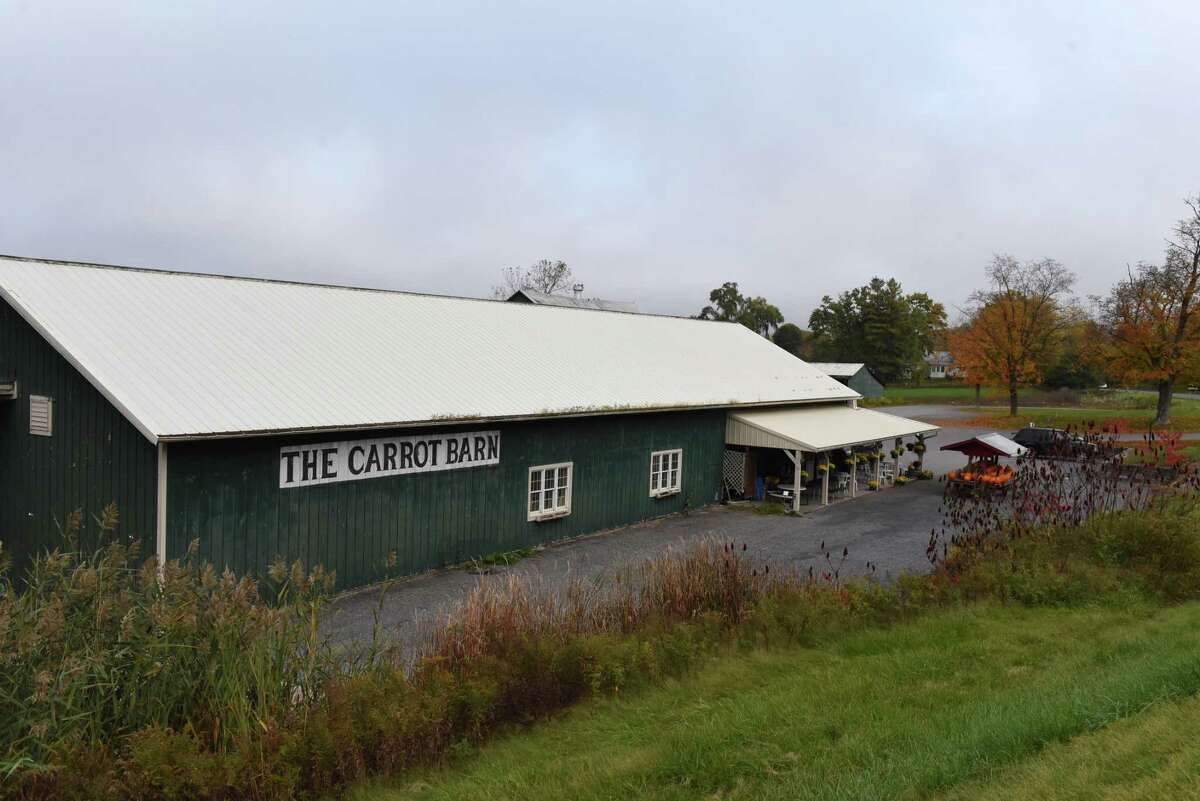 A large, low-slung building with a sign for The Carrot Barn.
