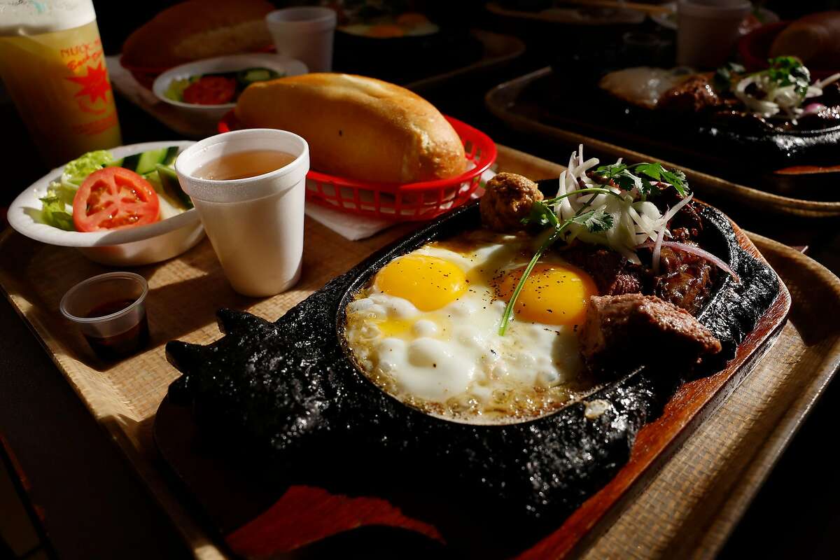 A cow-shaped cast iron plate with sunny-side up eggs