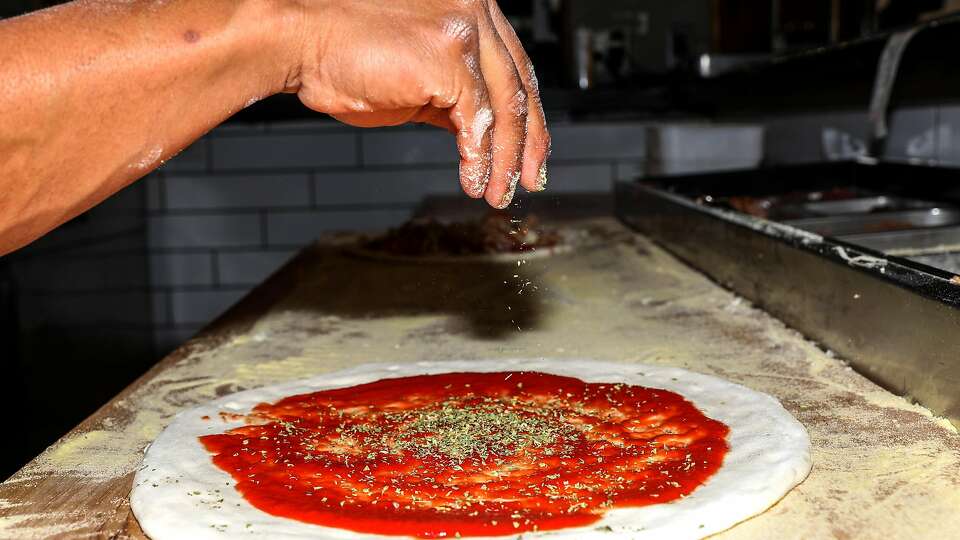 Pizza being prepared at Benchmark Pizzeria