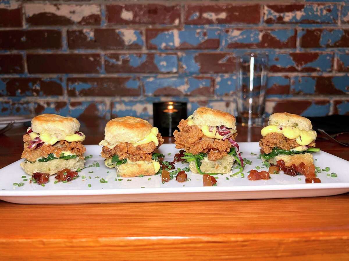Oyster sliders are built with fried oysters on biscuits with brown butter hollandaise and candied bacon at Bliss restaurant, marking its 10th year in Southtown.