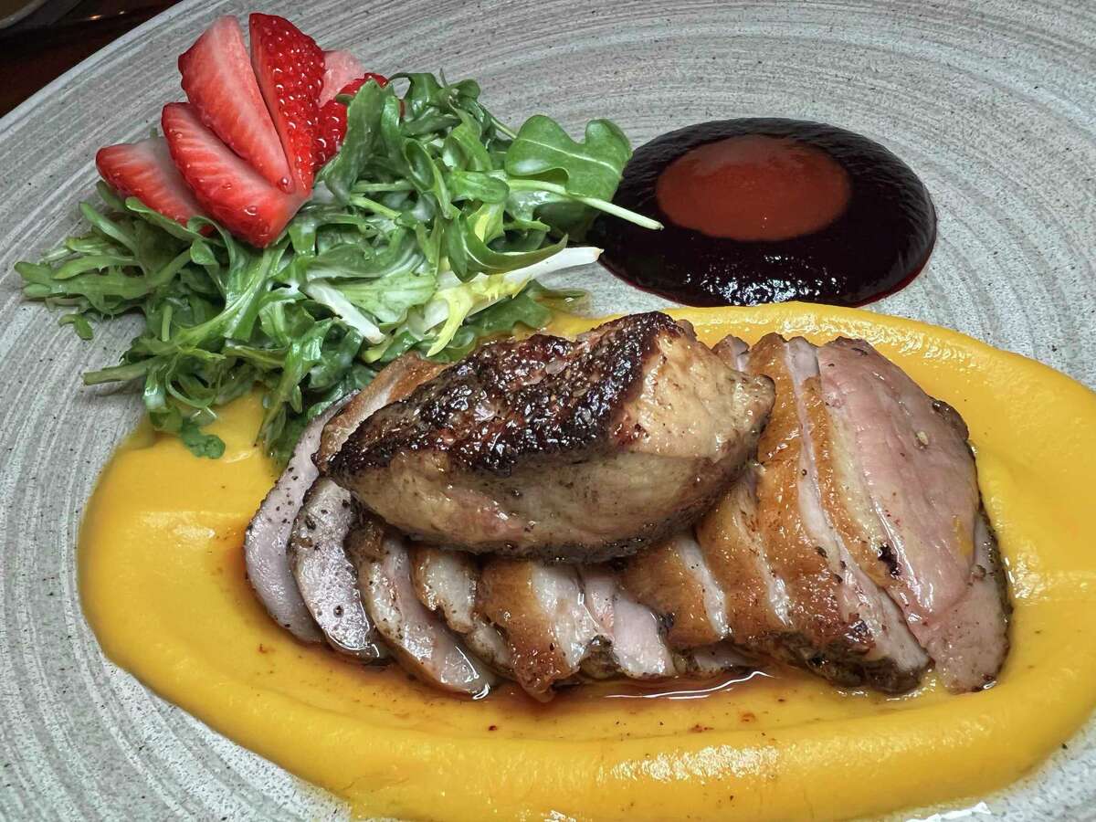 Grilled duck breast comes with foie gras, butternut squash, strawberries, strawberry sambal and blueberry gastrique at Bliss in Southtown.