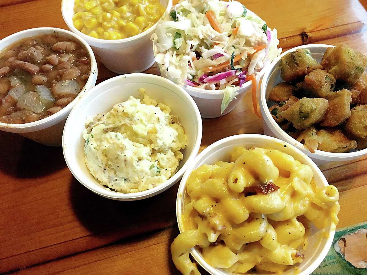 A half-dozen sides from Smoke Shack on Broadway in San Antonio. Clockwise from bottom: mac and cheese, loaded baked potato salad, beans, creamed corn, coleslaw and fried okra.