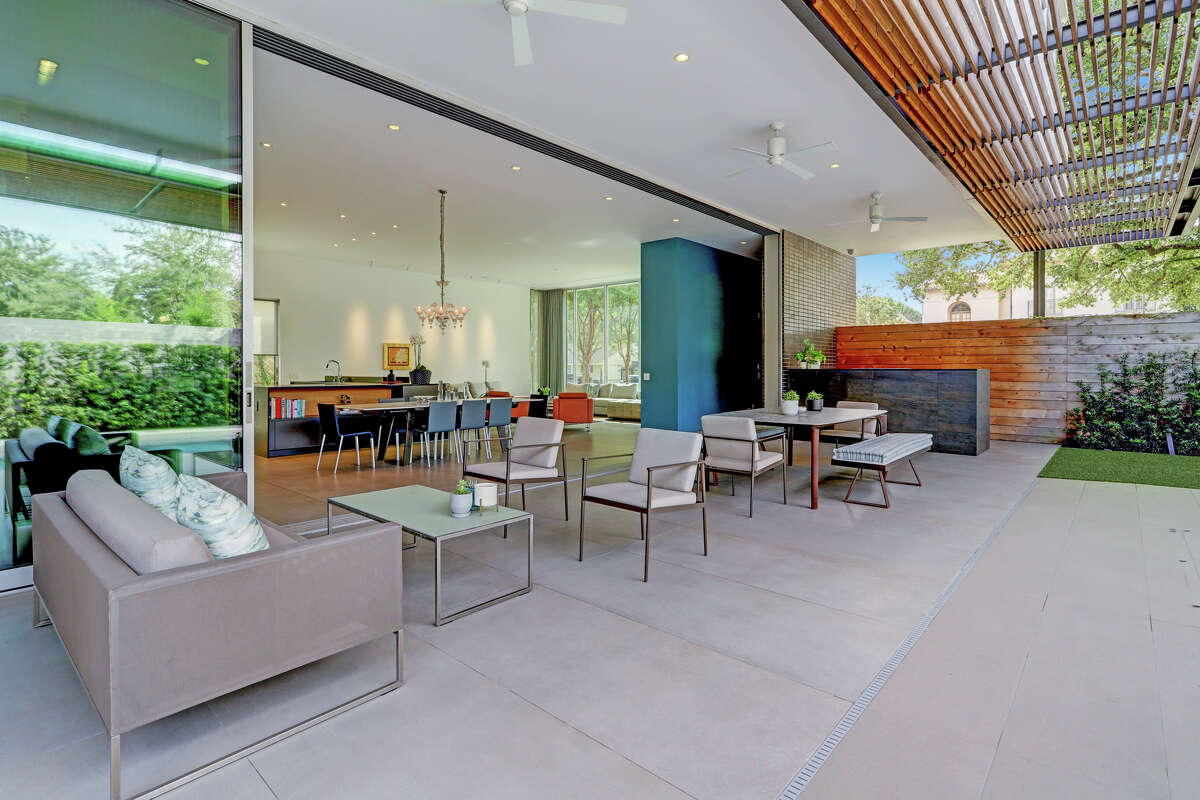 The open kitchen spills into an outdoor covered patio.