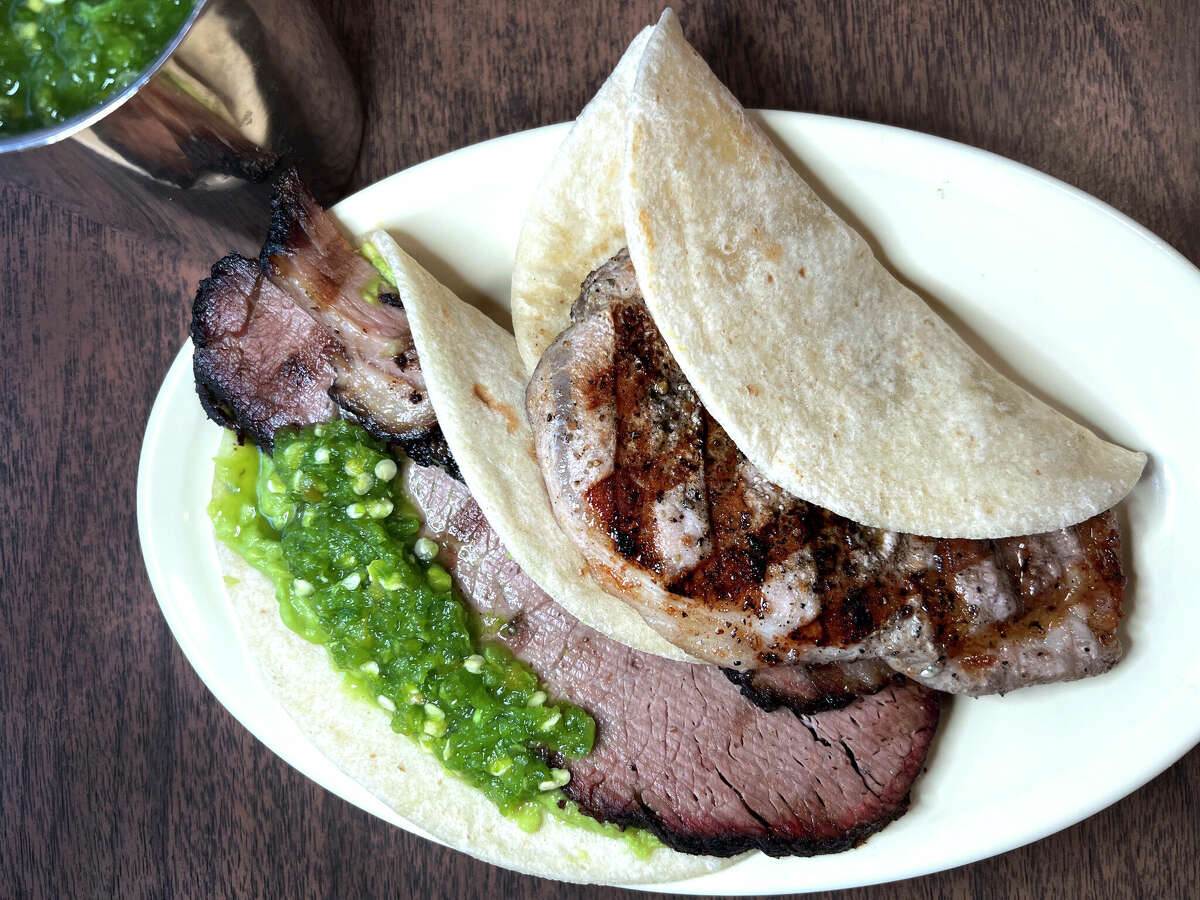 Tacos at Garcia's Mexican Food on Fredericksburg Road in San Antonio include smoked brisket with guacamole, left, and grilled pork chop.