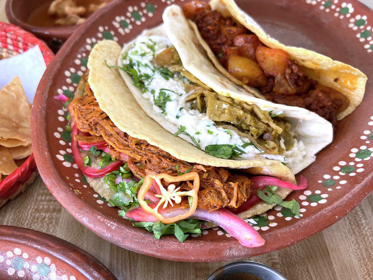 The menu at Tlahco Mexican Kitchen on San Pedro Avenue in San Antonio includes, clockwise from top, a cochinita pibil taco, a chilaquiles verdes taco, a papa-and-chorizo taco, cafe de olla, al pastor street tacos and fried tacos called tacos dorados.