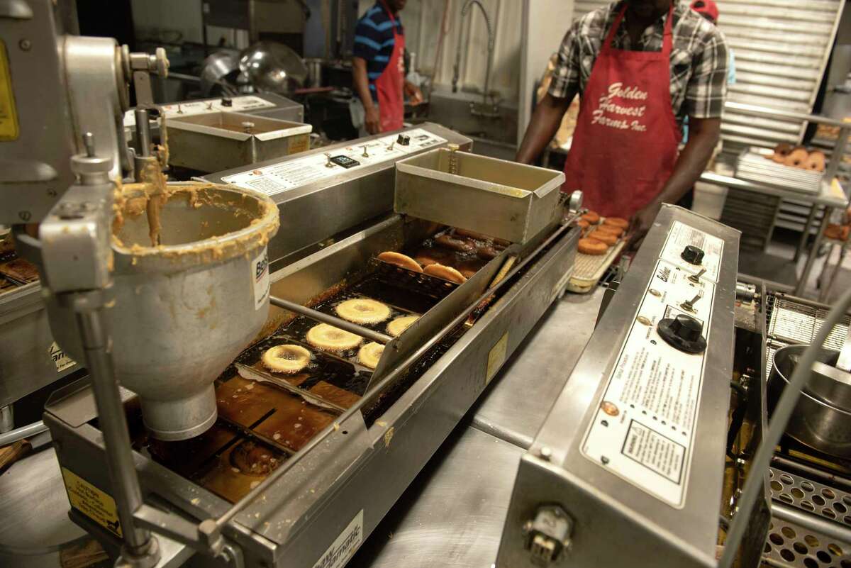 Cider doughnuts are made in an industrial kitchen.