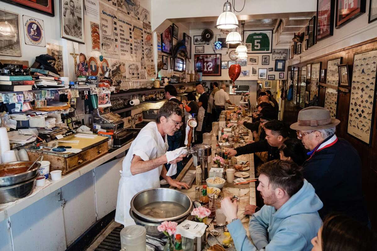 Customers eat lunch at the counter at Swan Oyster Depot