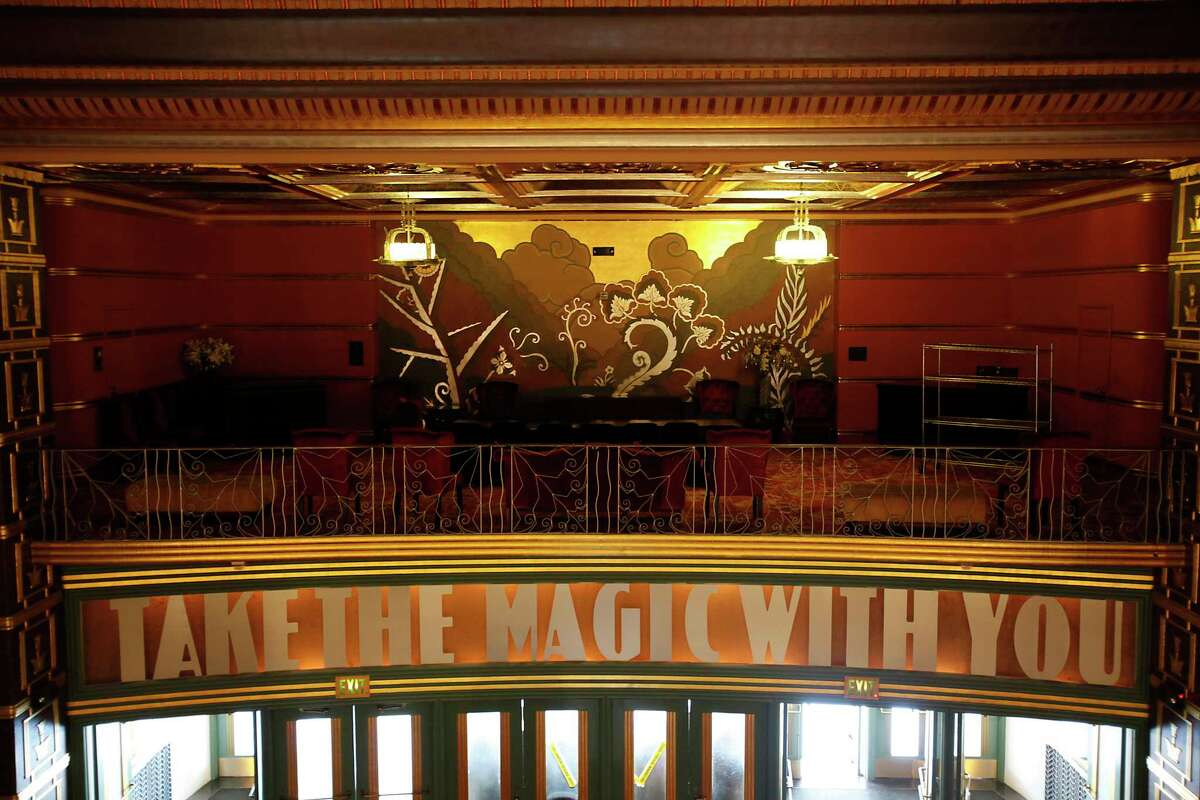 The inside of the Alameda Theatre where a "Take the Magic With You" sign hangs over the exit in the front of the theater.