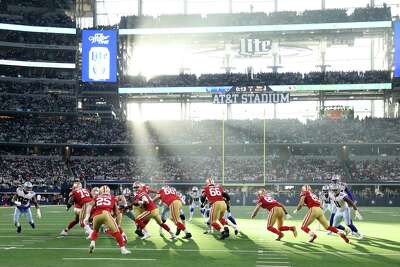 The Niners play the Dallas Cowboys in Arlington, Texas, as sunlight streams in through the stadium windows. 
