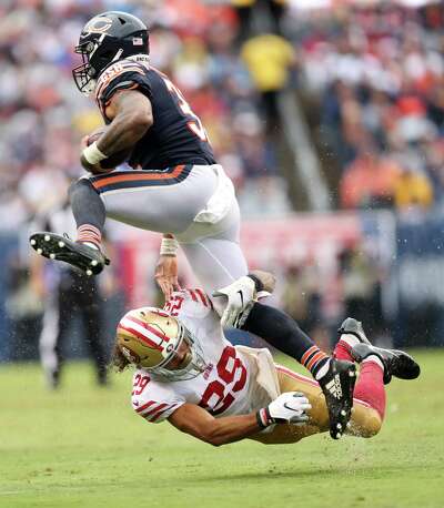 The 49ers’ Talanoa Hufanga grabs the leg of the Chicago Bears' David Montgomery.
