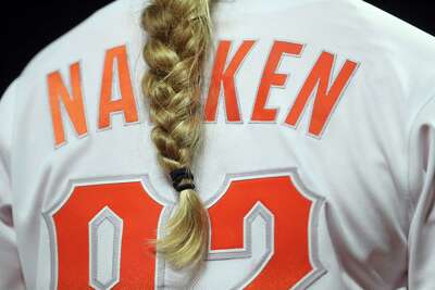 Close-up of back of Nakken's jersey with her long braid hanging over it.