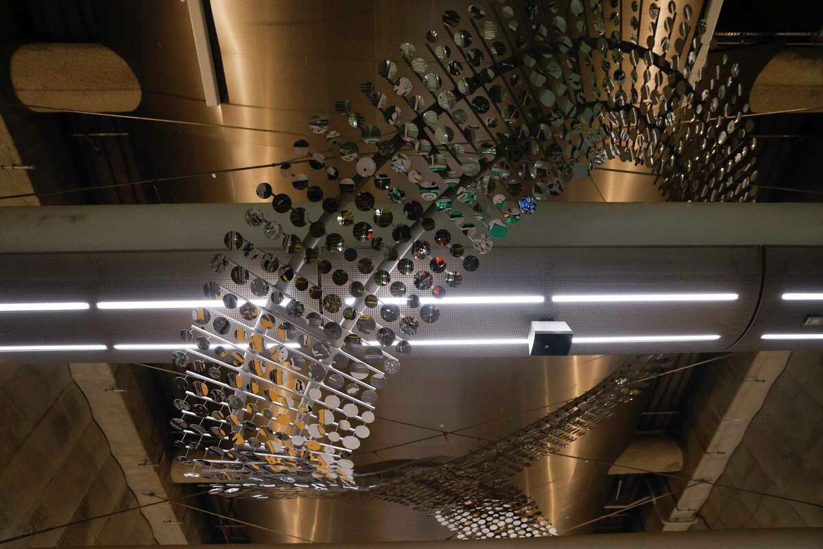 This suspended sculpture is meant to evoke an underground creek as it snakes above the station platform