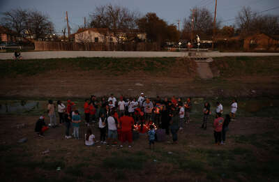 Mourners gather at a creek in memory of Kevin Donel Johnson, Jr. after he was fatally shot by San Antonio police.