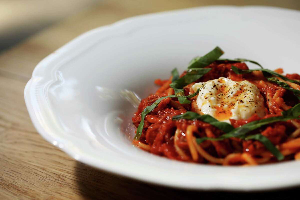 Spaghetti in a tomato suga with burrata in the center