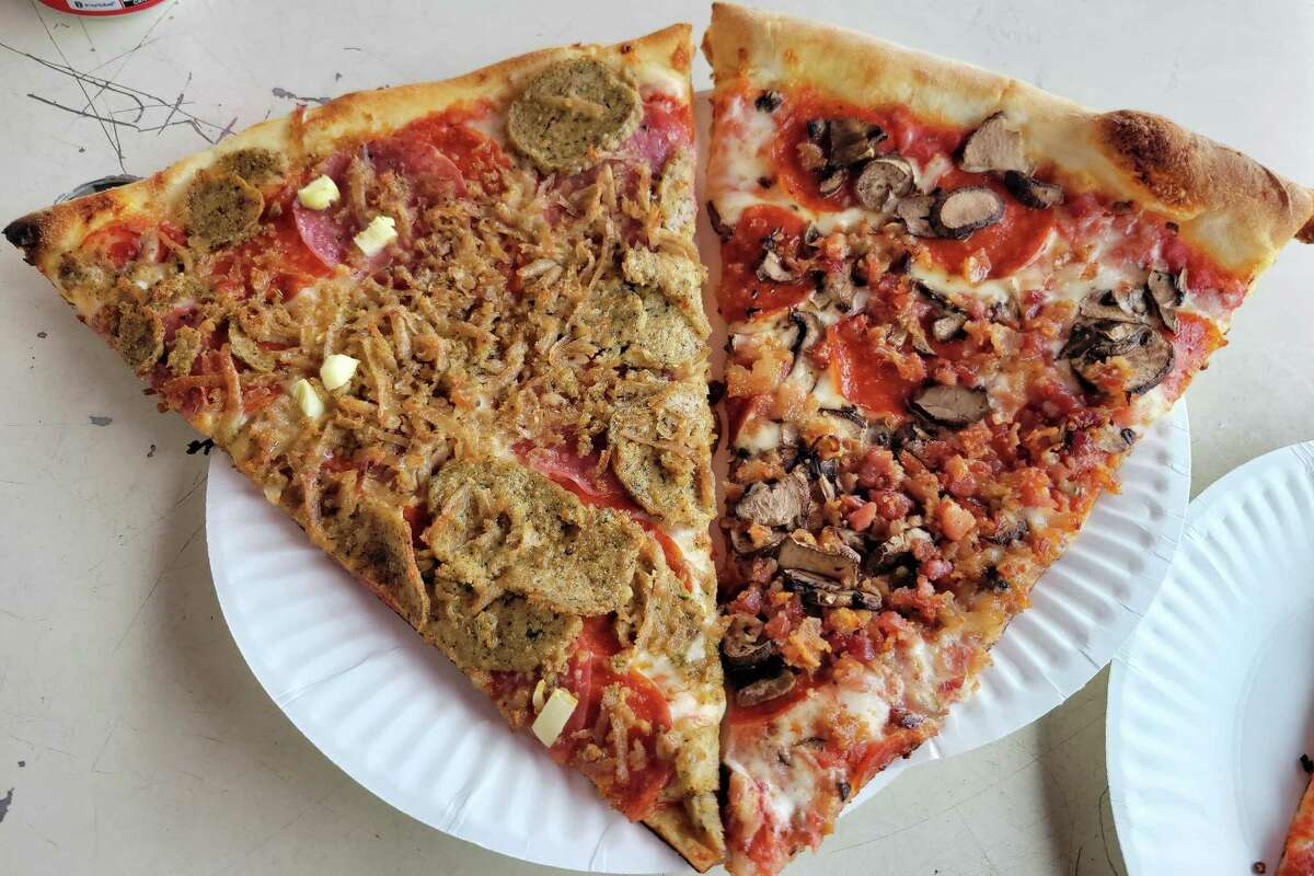 Two pizza slices on a paper plate