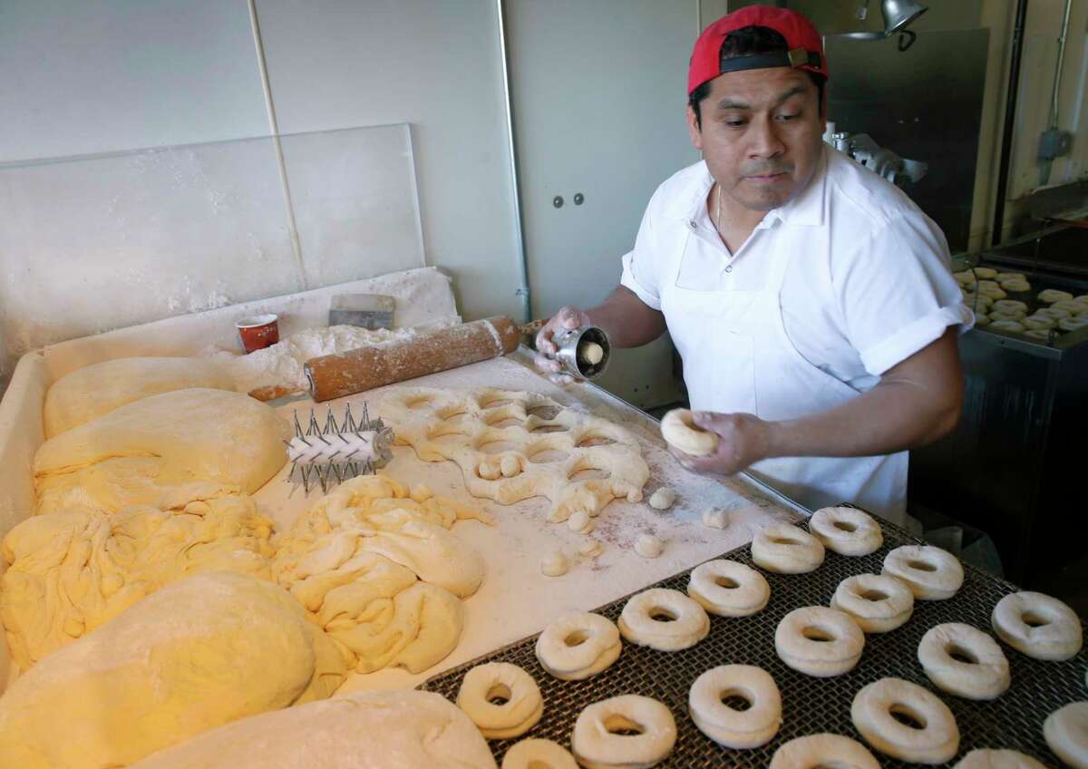 Man making doughnuts.