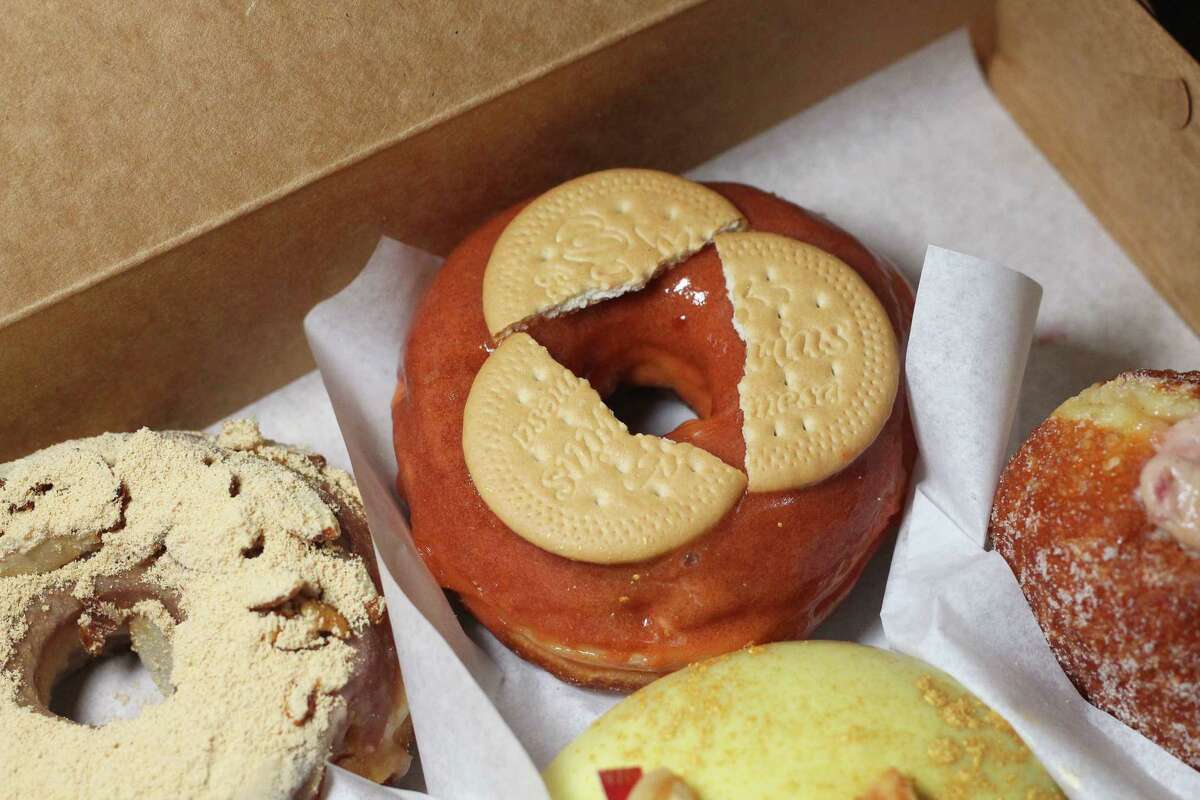 Close look at doughnut topped with cookies.