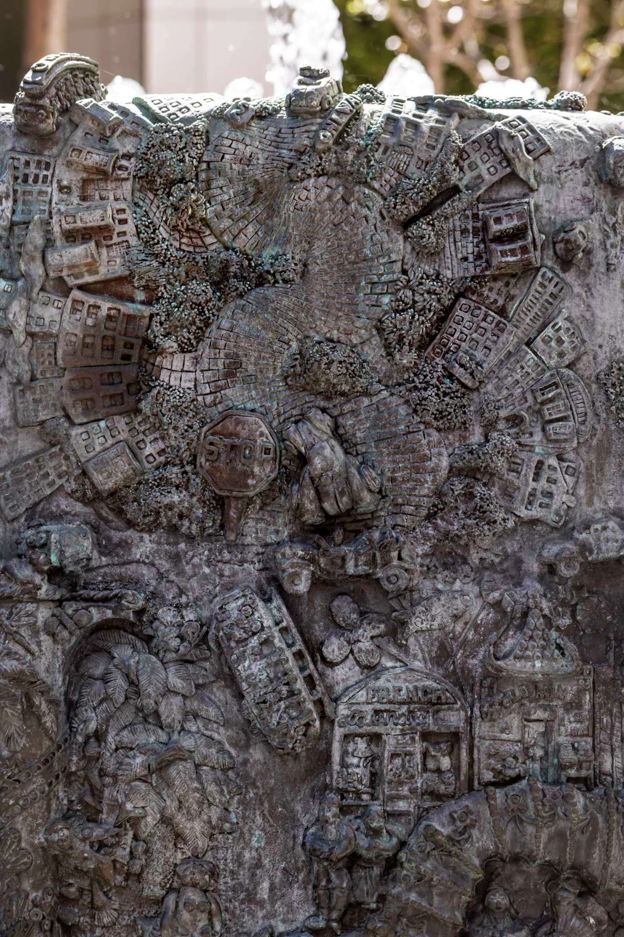 A detail photo of Ruth Asawa's "San Francisco Fountain" shows the curving depiction of Lombard Street with bricks, bending cars and a stop sign.