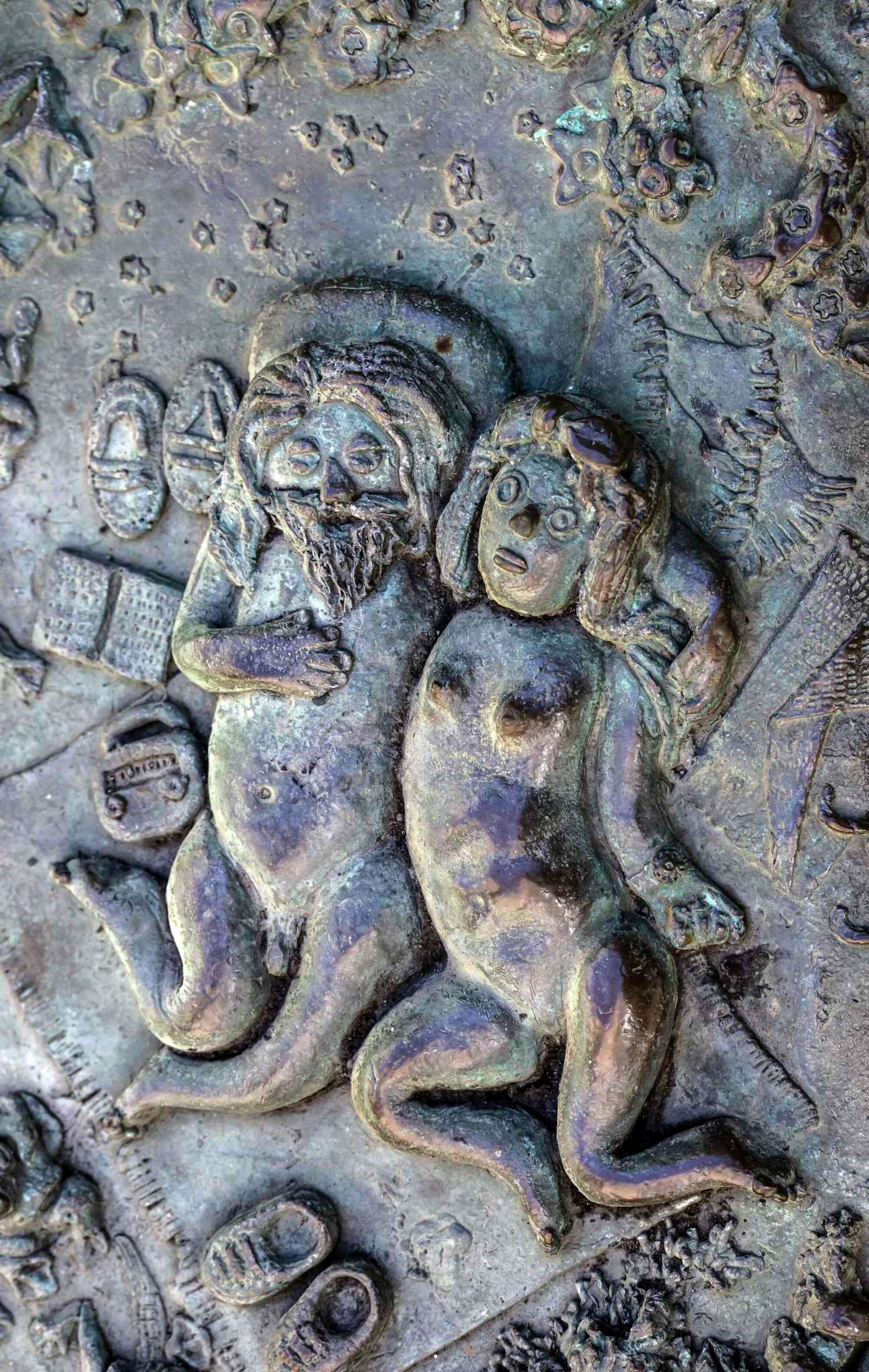 A detail photo of Ruth Asawa's "San Francisco Fountain" shows two nude figures sunbathing in a park scene.