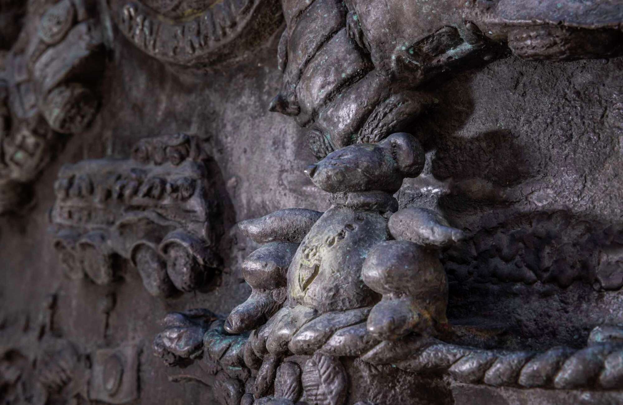 A detail photo of Ruth Asawa's "San Francisco Fountain" shows a small Snoopy figure, one of handful scattered around the densely detailed art work.