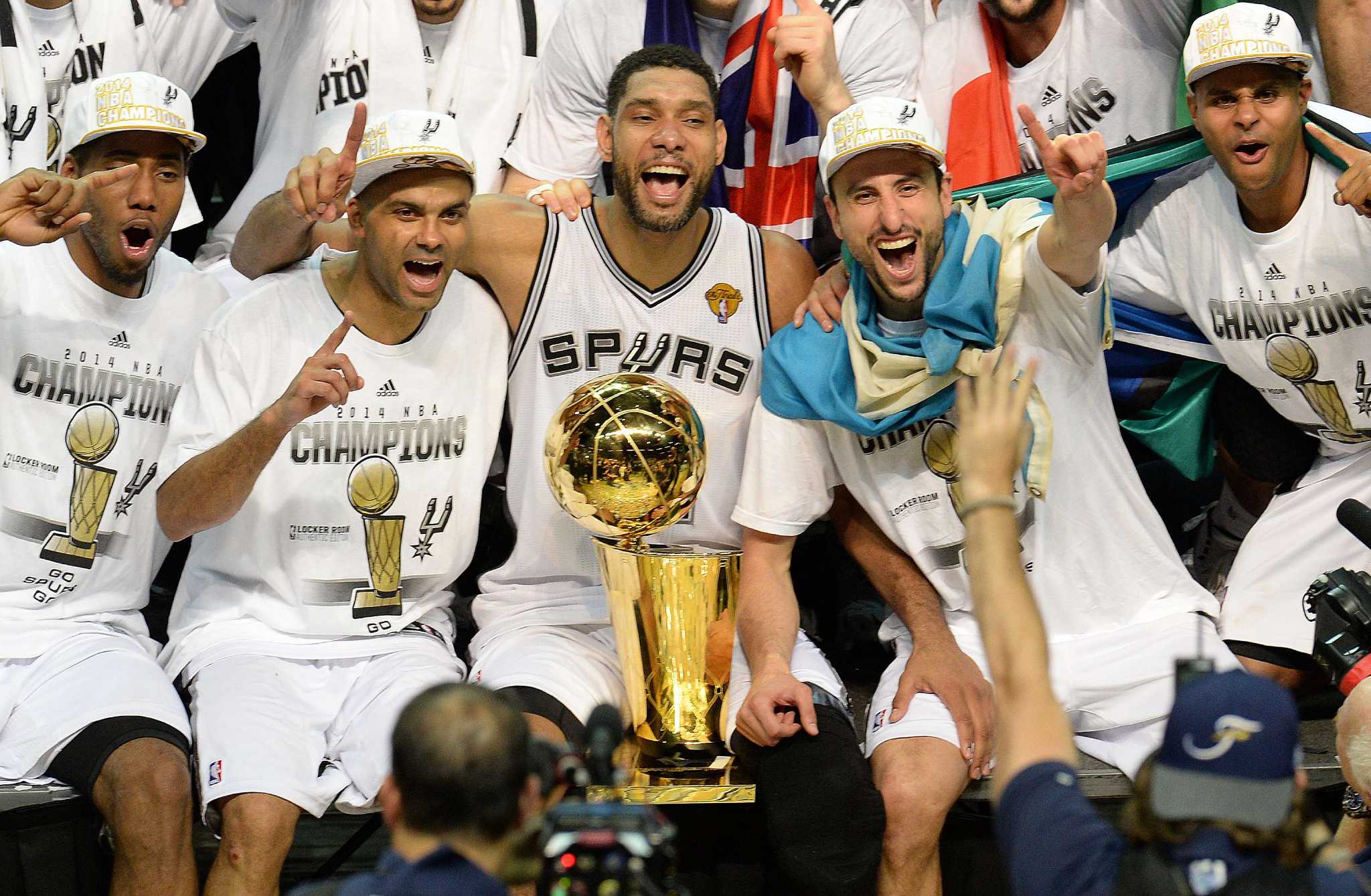 Tim Duncan, Tony Parker and Manu Ginobili and other Spurs players celebrating after winning the 2014 NBA FInals.