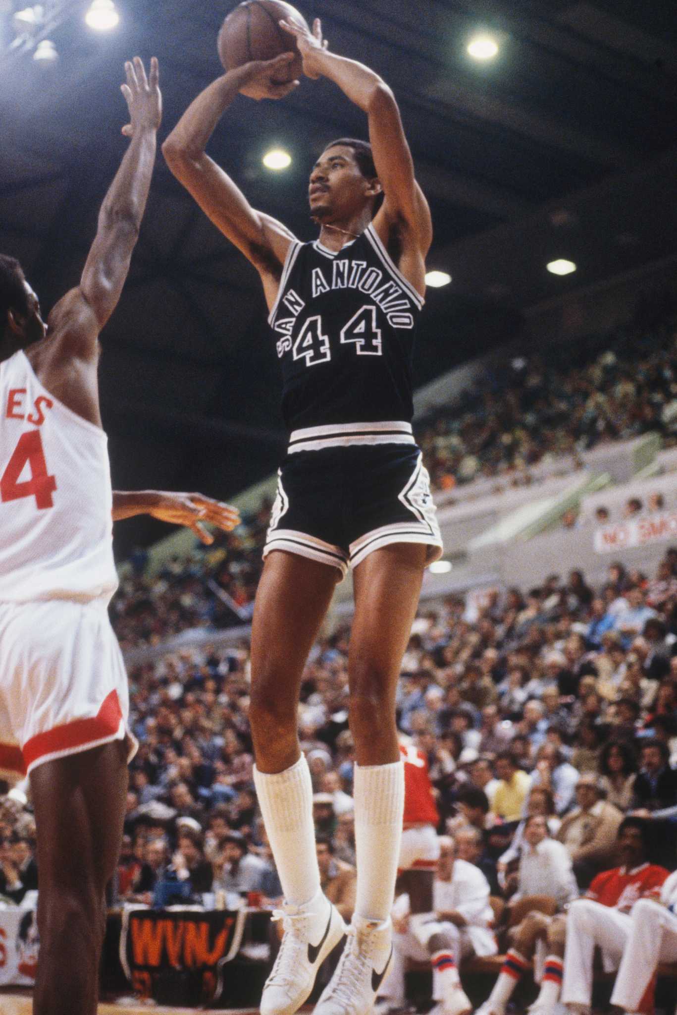 George Gervin taking a shot from the side.