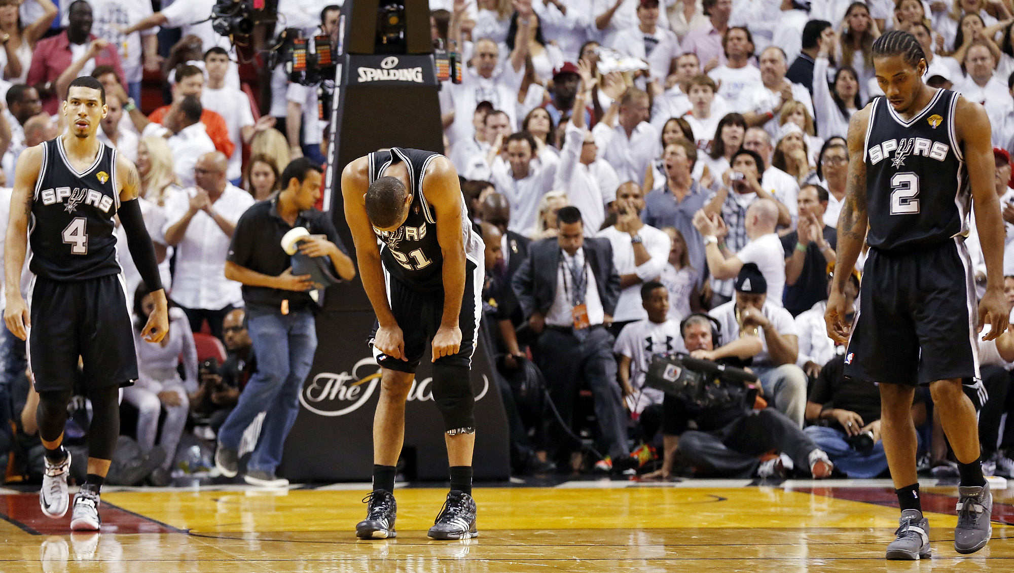 Tim Duncan bent over, grabbing his knees during the NBA Finals.