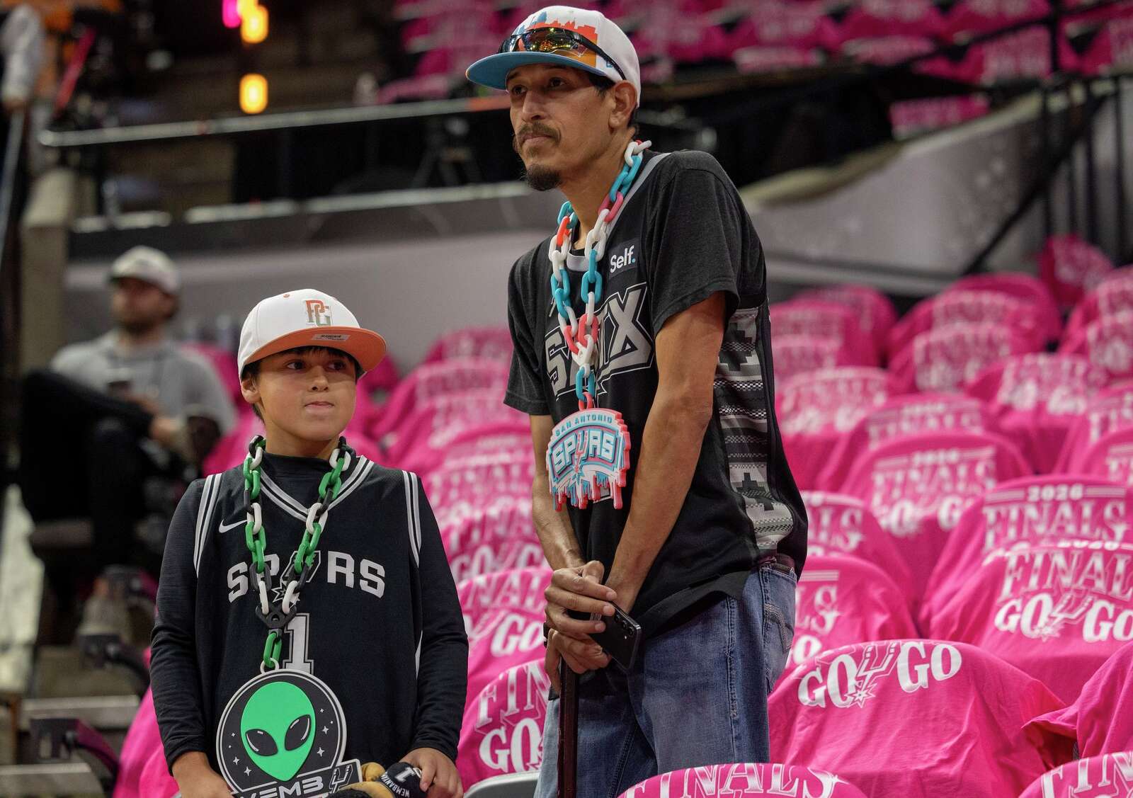 Steve Gutierrez and his grandson Jeremiah Gutierrez, 8, watch the Spurs warm up before Game 1 of the NBA Finals against the New York Knicks. (Andrew J. Whitaker/San Antonio Express-News)