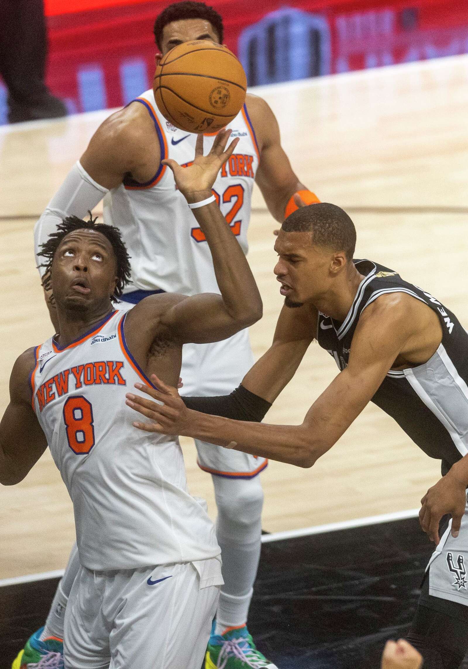 New York Knicks forward Og Anunoby looks at the ball while guarded by San Antonio Spurs center Victor Wembanyama during Game 1 of the NBA Finals. (Andrew J. Whitaker/San Antonio Express-News)