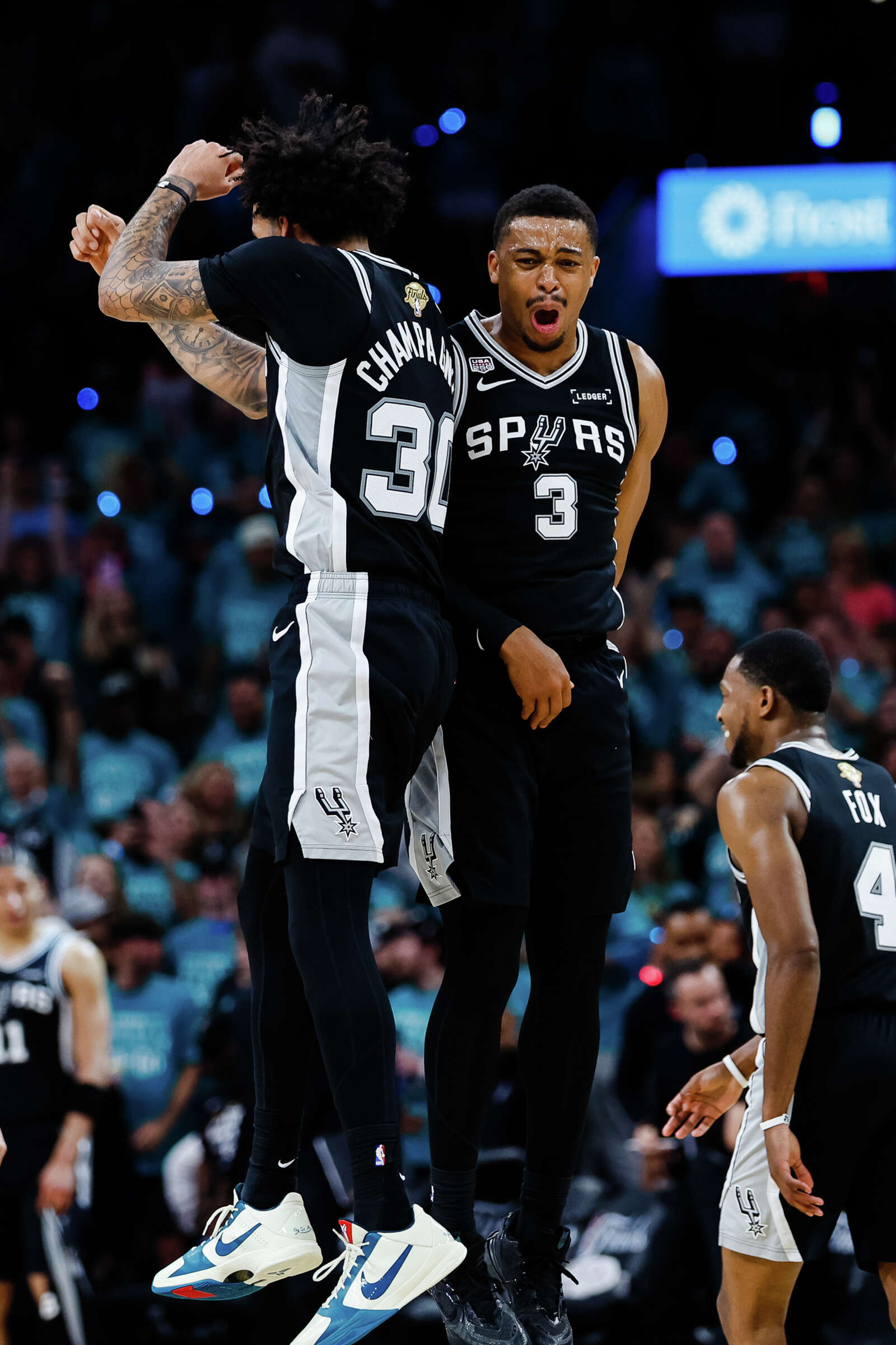Spurs forward Julian Champagnie and Spurs forward Keldon Johnson celebrate a play during Game 1 oft he NBA Finals against the New York Knicks. (Sam Owens/San Antonio Express-News)