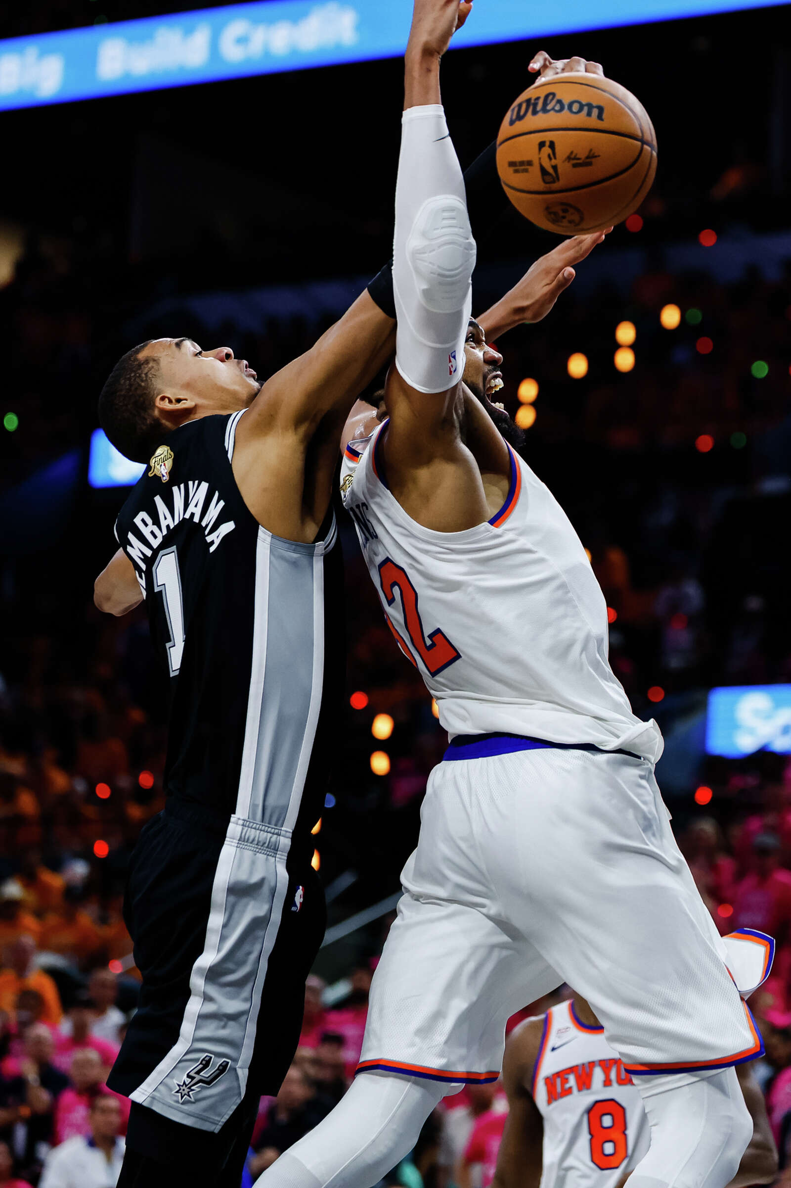 Spurs center Victor Wembanyama reaches around New York Knicks center Karl-Anthony Towns to block a shot during Game 1 of the NBA Finals. (Sam Owens/San Antonio Express-News)